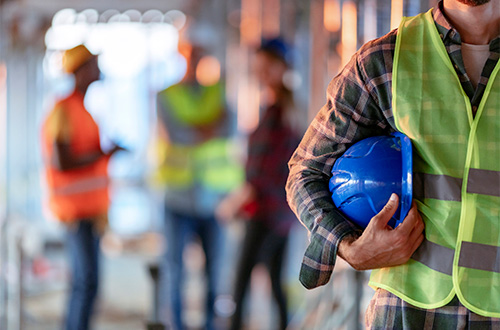 Construction worker holding a hard hat