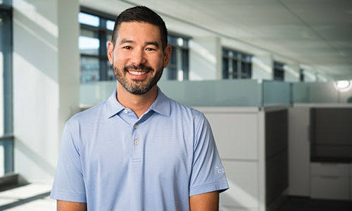 Texas Mutual Territory Management Specialist Jeff Sekiguchi smiling to camera.